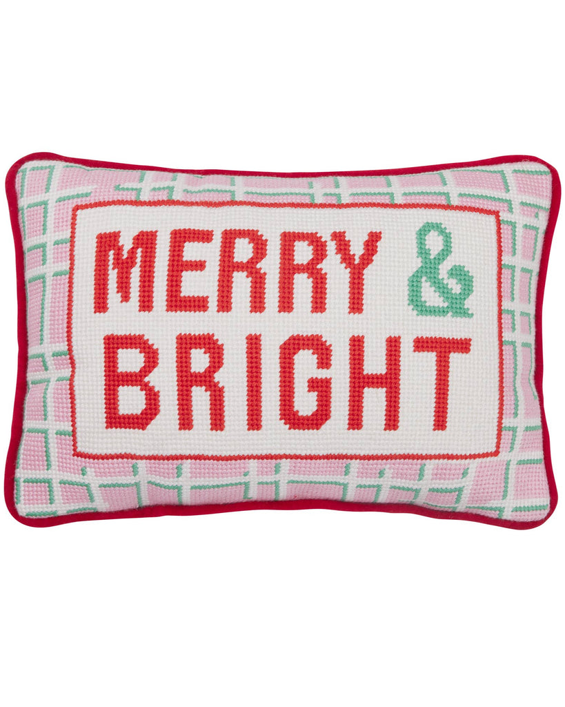 Decorative pillow with 'Merry & Bright' text on a white background